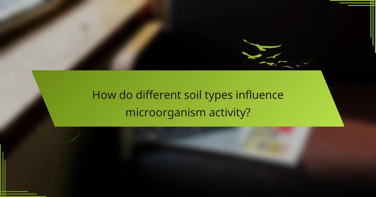 How do different soil types influence microorganism activity?